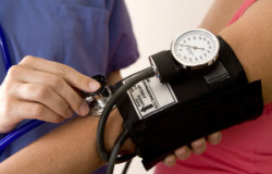 Doctor or nurse taking a patient's blood pressure