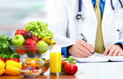 Nutritionist doctor man with vegetables working in the office