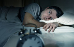 Man In Bed With Eyes Opened Suffering Insomnia And Sleep Disorde