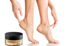 Closeup shot of a woman applying moisturizer to her leg and feet